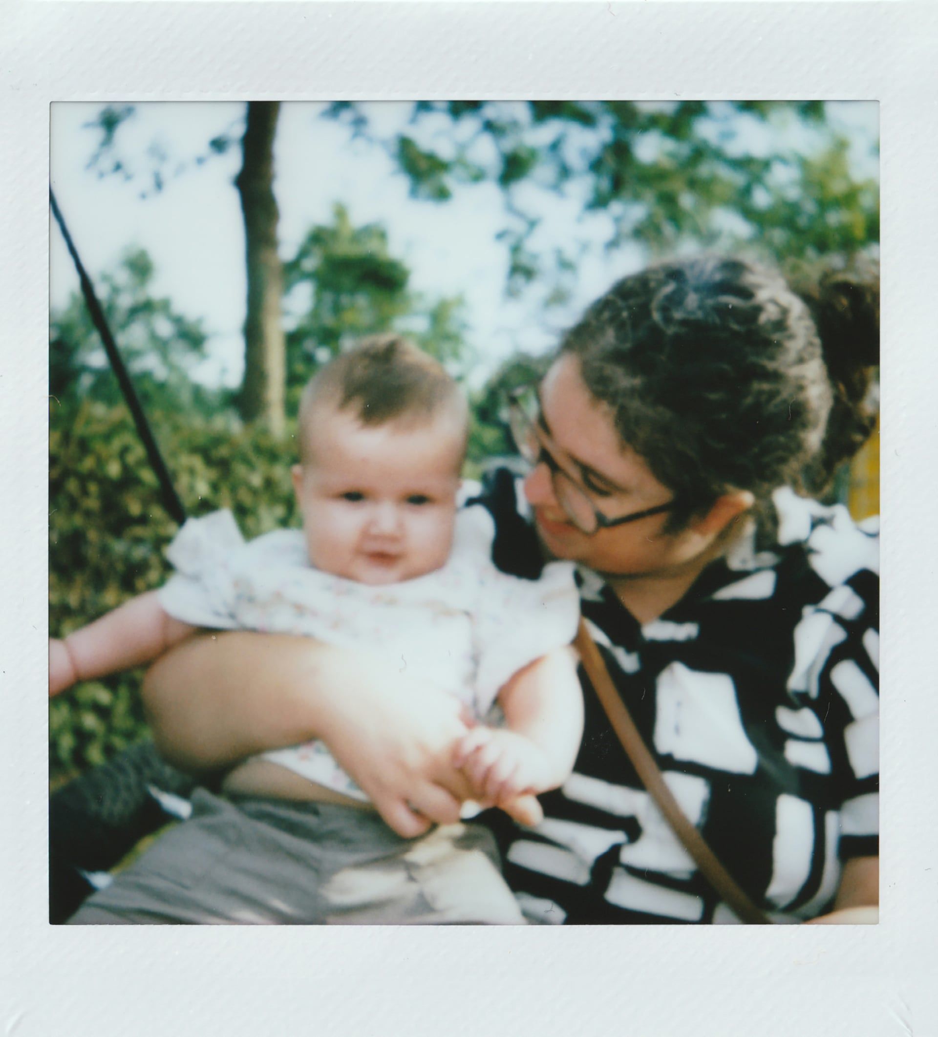 Grandmother holding grandchild in tender vintage family moment